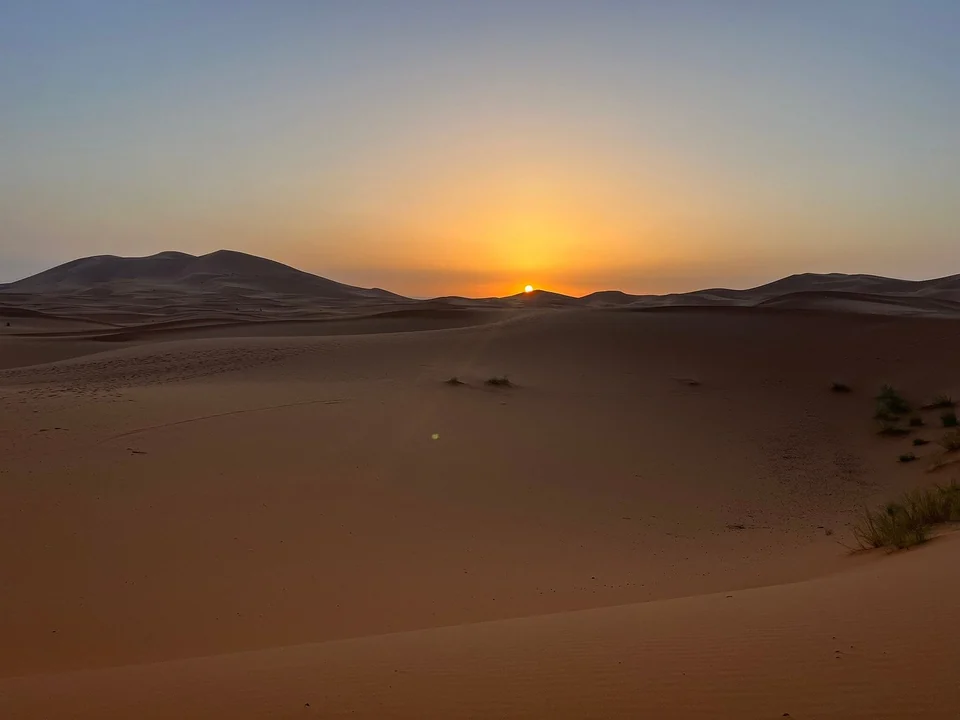 Sunset over the Merzouga dunes during a fourteen-day Morocco tour from Casablanca