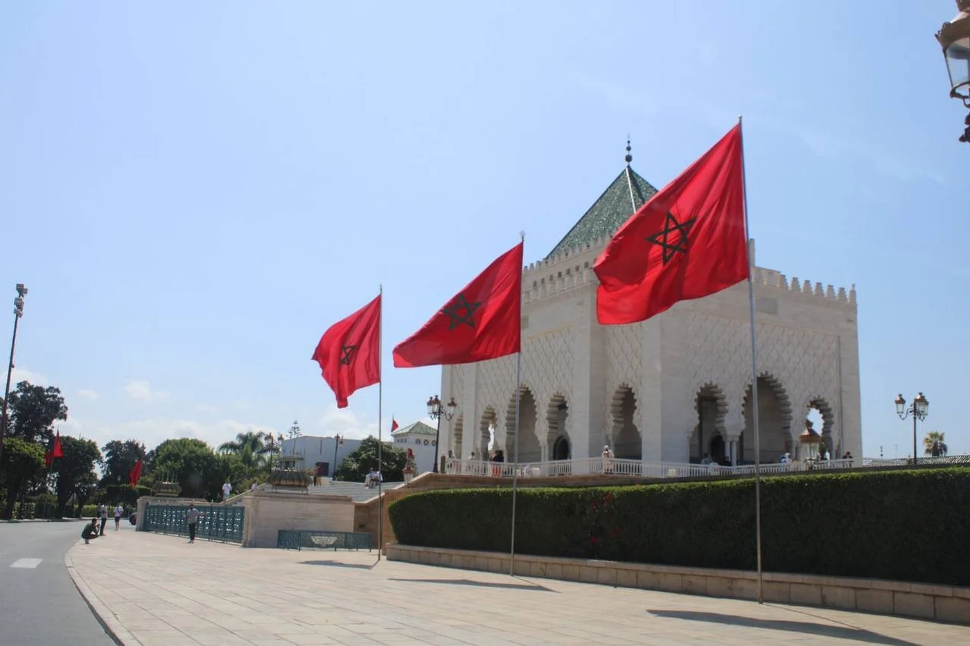 Moroccan flags beside a landmark in Rabat during a five-day Morocco tour