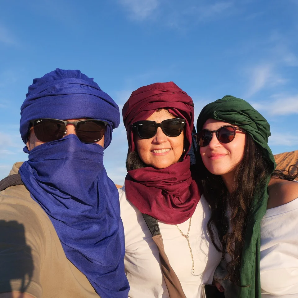 Travelers wearing desert scarves during a ten-day imperial cities and desert tour