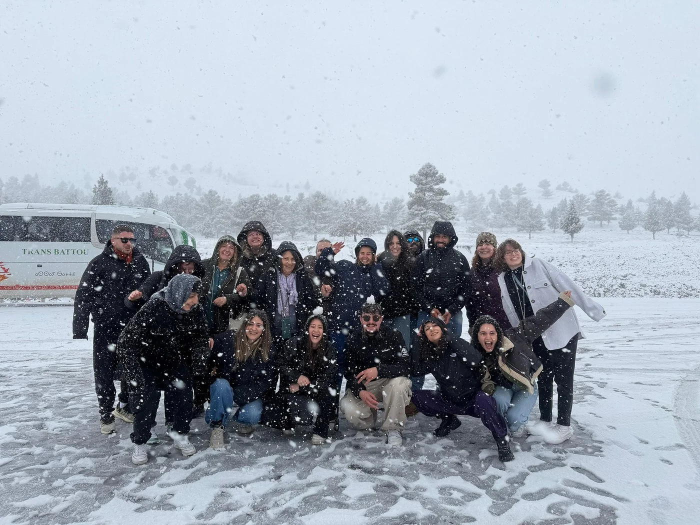 Travel group enjoying snowy scenery during a Middle Atlas day trip from Fes