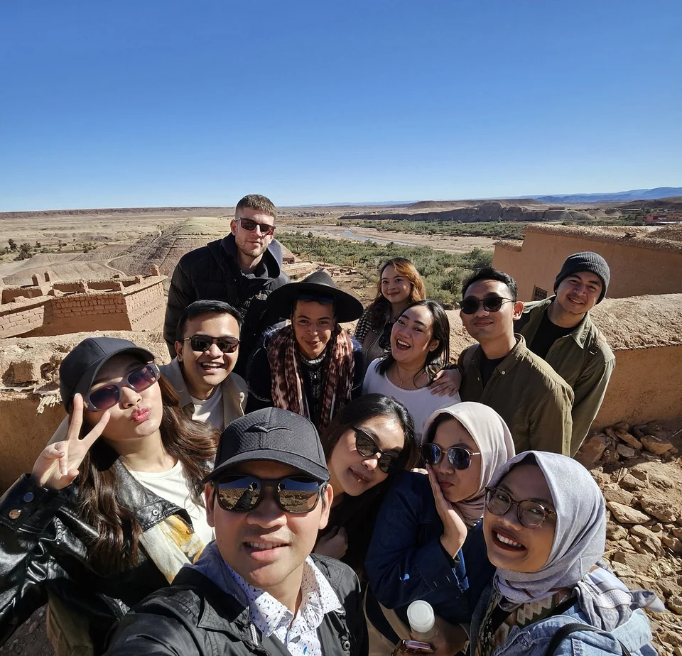 Travel group enjoying a viewpoint during an eight-day Morocco tour