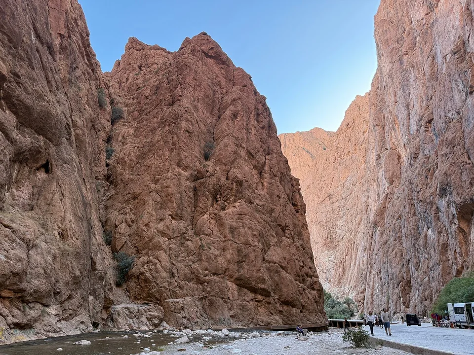 Towering limestone cliffs beside the riverbed in Todra Gorge